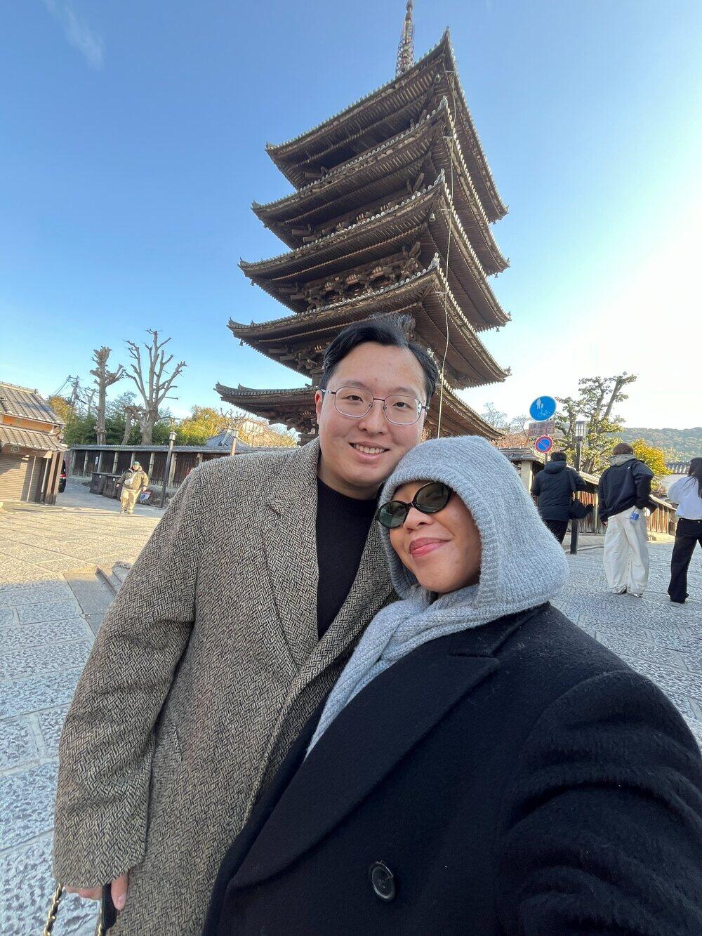 Alec and Shania together beside a pagoda